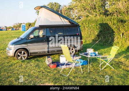 Mazda, Mazda Bongo, Mazda Bongo Friendee, Wohnmobil, Van, Vanlife, van life, mit, Pop-up, Dach, mit, Tisch, und, Stühle, Aufenthalt, Lifestyle, Sommer, August, auf, Sommer, Sommer, Tag, Camping, Campingplatz, Campingplatz, Pembrokeshire, West, Wales, Walisisch, GB, Großbritannien, Großbritannien, Vereinigtes Königreich, Vereinigtes Königreich, Stockfoto