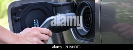 Buchse mit Handeinsätzen zum Laden von Elektroautos in Nahaufnahme Stockfoto