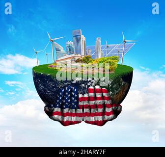 US-Flagge auf Händen hält den Planeten Erde mit einer sauberen Stadt, die auf erneuerbare Ressourcen angewiesen ist. Konzept der Rolle der Vereinigten Staaten beim Klimawandel. Elemente von dieser Stockfoto