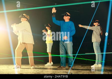 Die Familie trägt eine Virtual-Reality-Brille im Quest-Raum Stockfoto