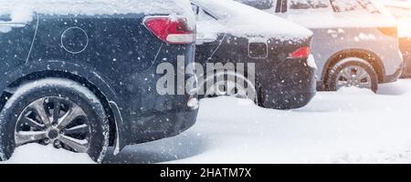 Stadtstraße Auffahrt Parkplatz mit vielen Autos von Schnee bedeckt stank nach schweren Schneesturm Schneefall am Wintertag durch schmutzige verschneite Haufen. Schneeverwehungen Stockfoto