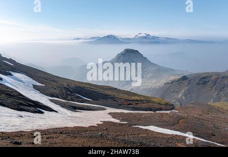 Tafelberge auf dem Wanderweg Fimmvoerouhals, karge, schneebedeckte Vulkanlandschaft mit einzelnen Vulkankrieren, Porsmoerk Nature Stockfoto