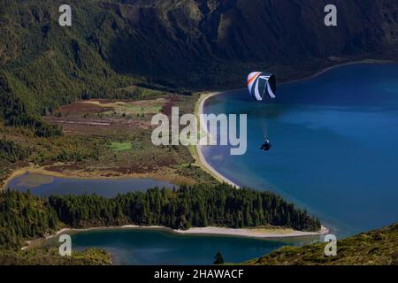 Gleitschirm im Flug über den Krater-See Lagoa do Fogo, Sao Miguel Island, Azoren, Portugal Stockfoto