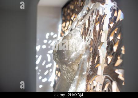 Wunderschöne weiße Bräute Kleid hängen von verzierten Fenster Stockfoto