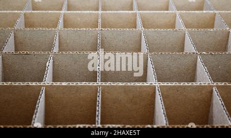 Abstrakter Hintergrund. Quadratische Trennwände aus Pappe aus nächster Nähe. Trennwände für den Transport empfindlicher Glasgegenstände. Stockfoto