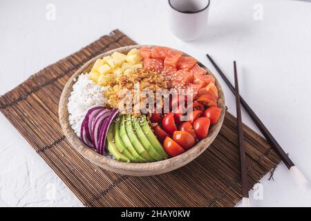 Von oben Schüssel mit leckeren Sack Schüssel mit rohen Zutaten in der Nähe von Essstäbchen und Tasse Sojasauce auf weißem Putz Oberfläche gelegt Stockfoto