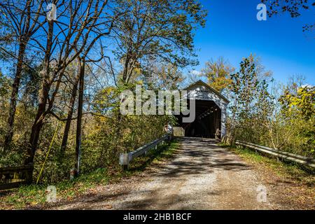 Die Cox Ford Covered Bridge überquert den Sugar Creek während des Herbstblattfarbwechsels in der Nähe von Bloomingdale in Parke County, Indiana. Stockfoto