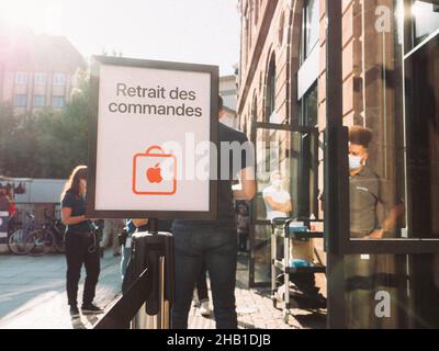 Sunlight Flare Retrait des commandes übersetzt als Abholung der Internet-Bestellung vor dem Apple Store in Place Kleber Stockfoto