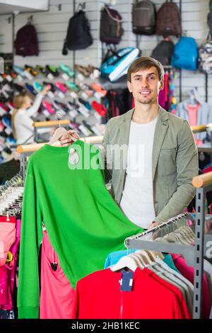 Junger Mann im Sportbekleidungsgeschäft. Stockfoto