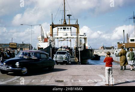 Autos, die von der Fähre auf der Isle of Wight kamen, MV Camber Queen oder MV Fishbourne, beide gebaut 1961 in Portsmouth, Hampshire, England, im Jahr 1962 Stockfoto