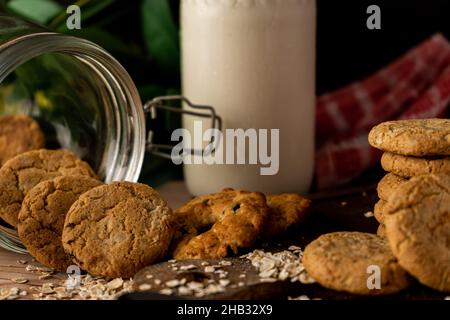 Nahaufnahme Eines heruntergefallenen Haferflocken Raisin Cookie Jar und eines Keksturms an der Seite. Gesundes Essen. Stockfoto
