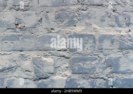 Nicht-lineares Muster aus alten, schäbigen Ziegelwänden mit natürlichen Mustern aus Farbsplittern. Grauer Backstein Wand Hintergrund Stockfoto