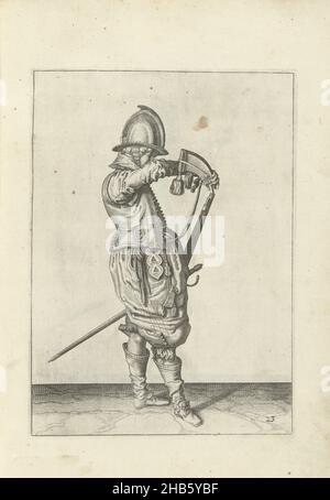 Soldat gießt Schießpulver in das Fass seines Steuerruders (Nr. 23), c. 1600, Ein Soldat, in voller Länge, nach rechts, hält ein Steuerruder (eine bestimmte Art von Schusswaffe) mit seiner linken Hand in der Nähe seines linken Oberschenkels, wobei der Lauf diagonal nach oben zeigt (nein 23), c. 1600. Mit der rechten Hand öffnet er ein Pulverhorn. Tafel 23 in der Anleitung zum Umgang mit dem Ruder: Kurze enseignement, sur la representation des figures, du droit maniement de l'Harquebuse. Teil der Illustrationen in einer französischen Ausgabe von J. de Gheyns Wapenhandelhe: J. de Gheyn, Maniement d'armes, d'arquebusses, mousquetz et piques : en Stockfoto