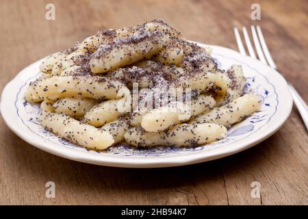 Mohnnudeln auf Holztisch mit Gabel Stockfoto