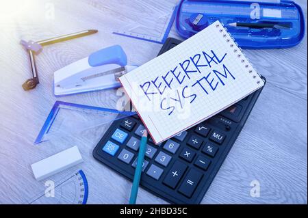 Handschriftszeichen Empfehlungssystem. Geschäftsidee: Eigenen Patienten zur Behandlung an einen anderen Arzt senden Leere Notizbuchseite mit Einem Rechner und Stockfoto