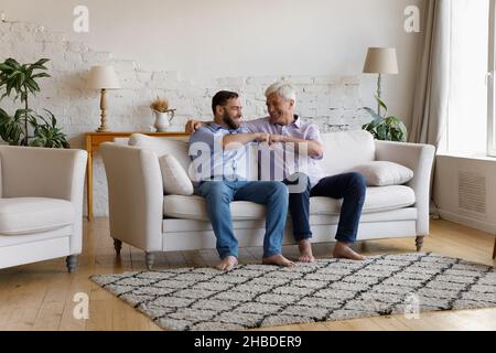 Freudige zwei männliche Generationen verbinden Familie stoßen Fäuste. Stockfoto