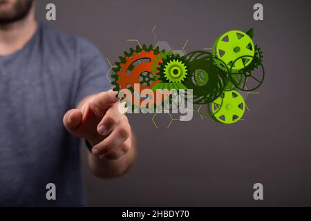 Eine Abbildung von Zahnrädern und einem Mann im Hintergrund Stockfoto