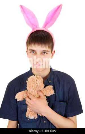 Kindliche Teenager mit Hasenohren und Teddybär isoliert auf dem weißen Hintergrund Stockfoto