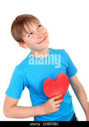 Kind mit roter Herzform ist Träumend isoliert auf dem weißen Hintergrund Stockfoto