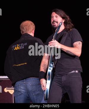 Prinz Harry begrüßt Dave Grohl von den Foo Fighters vor ihrem Auftritt auf der Bühne bei der Abschlussfeier der Invictus Games im Queen Elizabeth Park in East London. Stockfoto