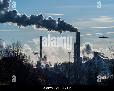 Emissionen der Fabrik in der Luftverschmutzung - Schornsteine der Zuckerrübenfabrik - hinterleuchteter Rauch und Dampf stammen aus der britischen Zuckerfabrik Bury St Edmunds Suffolk UK Stockfoto