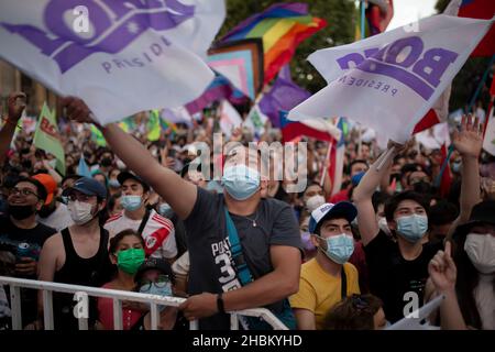 Santiago, Chile. 19th Dez 2021. Während der Feier winken die Anhänger von Gabriel Boric mit seinem Namen.der Kandidat des Apruebo-Dignidad-Pakts gewinnt die Präsidentschaftswahlen 2021 in Chile mit mehr als der Hälfte der Stimmen gegen den rechtsradikalen Kandidaten Jose Antonio Kast. Kredit: SOPA Images Limited/Alamy Live Nachrichten Stockfoto