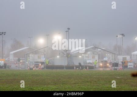 Das Bild vom 19th 2021. Dezember zeigt die geschäftige Fahrt durch das Testzentrum in Milton, Cambridge, unter Flutlicht an einem nebligen Sonntagmorgen, während die Leute zu ihren PCR-Tests gehen. Mit der Zunahme der Omicron-Fälle steigt die Nachfrage nach Tests, da einige Personen keinen Platz für einen Test buchen oder Testkits zu Hause erhalten können. Stockfoto