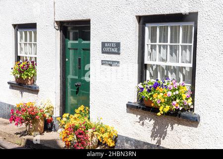 Blumen in Fensterkästen und Töpfen vor einem Ferienhaus im Exmoor-Dorf Porlock, Somerset UK Stockfoto
