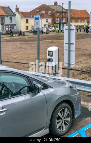 Ein Nissan-Elektroauto, das an öffentlichen Ladestationen in Wells-next-the-Sea an der nördlichen Norfolk-Küste lädt. Stockfoto