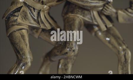 Bronzestatuette von zwei Männern, die aus nächster Nähe miteinander ringen. Champion Wrestling Cup. Metallfigur beim Ringen Stockfoto