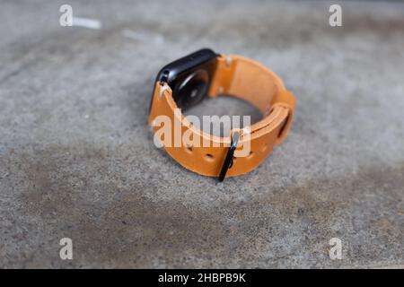 Hellbraunes braunes Lederuhrarmband Handarbeit auf Holz Stockfoto