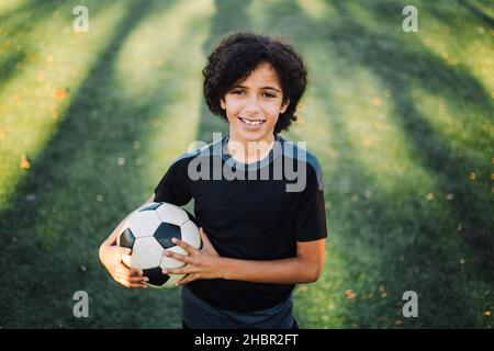 Portrait eines Mädchens mit Fußball auf dem Sportplatz Stockfoto