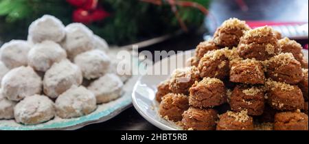 Griechische Weihnachtsdesserts. Traditionelle hausgemachte Melomakarona und Kourabiedes in Teller Nahaufnahme Ansicht Stockfoto