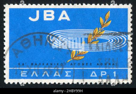 GRIECHENLAND - UM 1965: Briefmarke gedruckt von Griechenland, zeigt Games Emblem und 'JBA', um 1965 Stockfoto