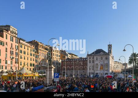 Genua, Ligurien, Italien - 10 23 2021: Menschenmenge bei einer Protestkundgebung ohne Green Pass auf der Piazza Caricamento mit dem Palazzo San Giorgio im Hintergrund Stockfoto