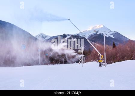 Bansko, Bulgarien - 21. Dezember 2021: Bulgarisches Winter-Skigebiet-Panorama mit Gondelbahnen Kabinen, Blick auf die Pirin Berggipfel und Piste Stockfoto