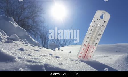 Das Thermometer liegt im Winter auf dem Schnee und zeigt niedrige negative Lufttemperatur. Meteorologische Bedingungen im rauen Klima in der nördlichen Regi Stockfoto