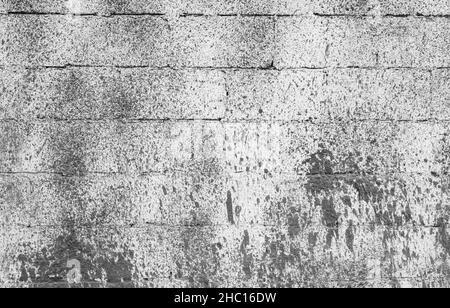 Alte graue Ziegelwand mit Farbspritzern, Hintergrundfotostruktur Stockfoto