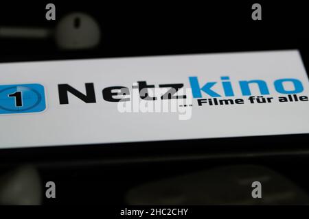 Rheinbach, Deutschland 5. Juni 2021, das Logo des Streaming-Dienstes "Netzkino" auf dem Bildschirm eines Smartphones mit weißen Kopfhörern Stockfoto