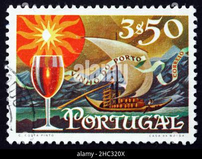 PORTUGAL - UM 1970: Eine in Portugal gedruckte Marke zeigt ein Glas Wein und eine Barge mit Fässern am Fluss Douro, Portwein Export, um 1970 Stockfoto