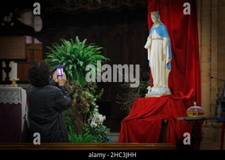 Moncalieri, Italien. 23rd Dez 2021. Die Statue der seligen Madonna von Batnaya, die von Soldaten des Daesh verstümmelt wurde und in der Ninive-Ebene im Irak gefunden wurde, ist in der gotischen Kirche Santa Maria della Scala zu sehen. Quelle: MLBARIONA/Alamy Live News Stockfoto