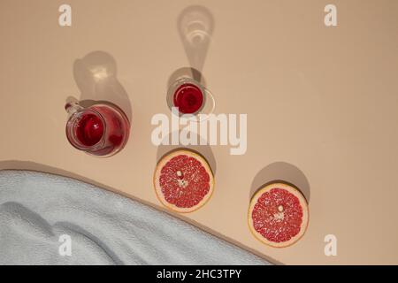 Sommerarrangement mit hellblauem Strandtuch und erfrischendem Erfrischungskonzept für kalte Getränke. Minimale Ästhetik. Stockfoto