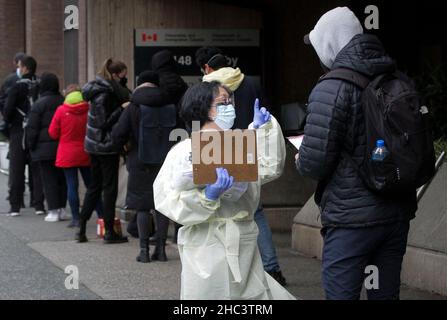 Vancouver, Kanada. 23rd Dez 2021. Ein Mitarbeiter des Gesundheitswesens spricht am 23. Dezember 2021 mit einem Bewohner einer temporären COVID-19-Teststelle in Vancouver, Kanada. Kanada hat am Donnerstag einen neuen Tagesrekord von 20.699 COVID-19 Fällen aufgestellt, was die Gesamtzahl auf 1.945.754 Fälle mit 30.131 Todesfällen nach CTV bringt. Quelle: Liang Sen/Xinhua/Alamy Live News Stockfoto