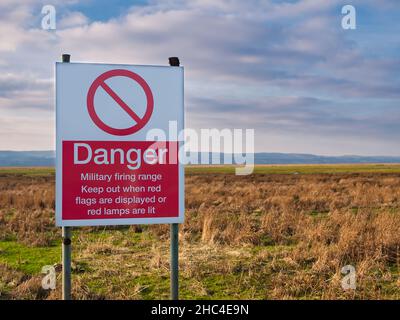 Ein rot-weißes Schild in englischer Sprache warnt die Öffentlichkeit davor, sich von Land fernzuhalten, das für den Einsatz als militärischer Schießplatz bestimmt ist. Stockfoto