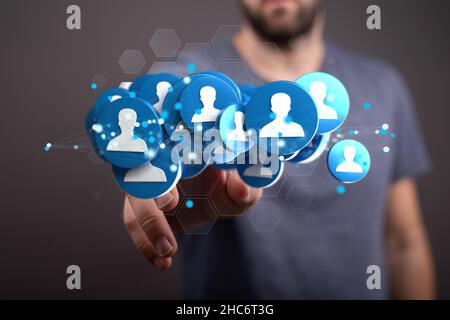 Männliche Hand hält eine Illustration einer Gruppe von Menschen - Netzwerk-Konzept Stockfoto