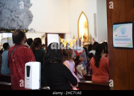 Bangkok, Thailand. 25th Dez 2021. Thailand : Christen besuchen die Heilige Kommunion anlässlich der Weihnachts- und Silvesternacht 2021 in der Holy Redentor Church in Bangkok unter dem epidemischen Coronavirus (COVID-19) Präventionsmaßnahmen wie das Tragen einer Maske, soziale Distanzierung. (Bild: © Teera Noisakran/Pacific Press via ZUMA Press Wire) Bild: ZUMA Press, Inc./Alamy Live News Stockfoto