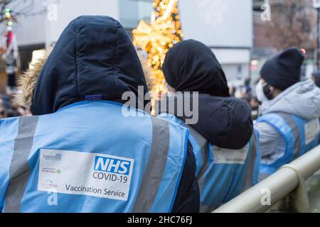 London, Großbritannien 25December 2021. NHS-Mitarbeiter und ehrenamtliche Mitarbeiter der Gemeinde verbringen ihren Weihnachtstag im Rathaus von Redbridge und bieten Coronavirus-Impfstoff und Jingle Jab für alle qualifizierten Personen als bestes Weihnachtsgeschenk seiner Art an. Sie schützen alle, da sich Omicron-Fälle alle zwei Tage verdoppeln. Quelle: Xiu Bao/Alamy Live News Stockfoto