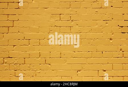 Hintergrund Muster Textur aus einem hellen gelben Ziegelwand Stockfoto