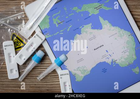 Covid Heimtests auf einem Tisch neben einer Karte von Australien Stockfoto