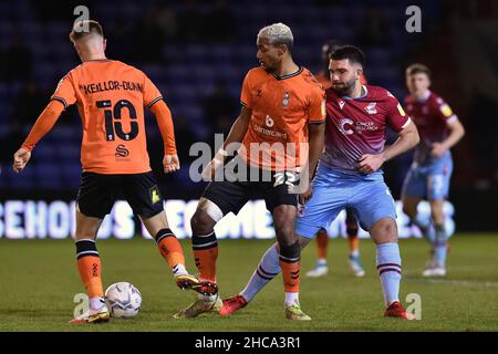 OLDHAM, GROSSBRITANNIEN. DEZ 26th Davis Keillor-Dunn von Oldham Athletic und Raphaël Diarra von Oldham Athletic vertuschen sich mit Harry Bunn von Scunthorpe während des Spiels der Sky Bet League 2 zwischen Oldham Athletic und Scunthorpe United am Sonntag, dem 26th. Dezember 2021 im Boundary Park, Oldham. (Kredit: Eddie Garvey | MI News) Stockfoto